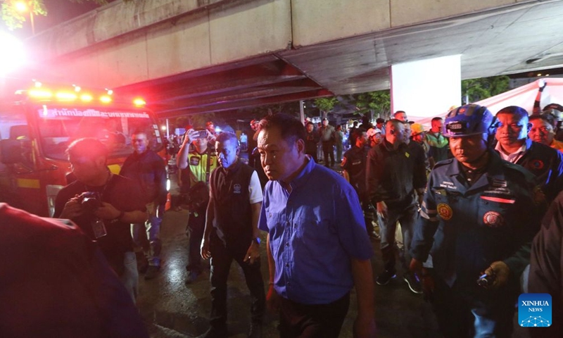 Thai Prime Minister Anutin Charnvirakul (C, front) arrives at the scene after a fire broke out at a pub in Bangkok, Thailand, July 13, 2026.
