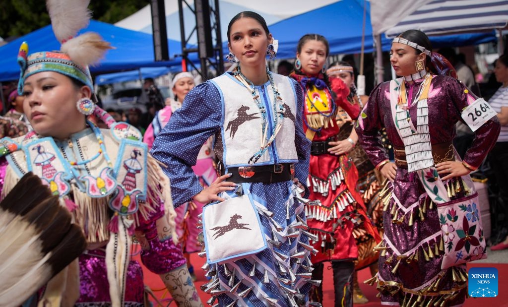 Members of Indigenous communities perform during the Squamish Nation Youth Pow-Wow in North Vancouver, British Columbia, Canada, on July 12, 2026. The annual event brought together Indigenous youth, dancers, drummers and community members to celebrate First Nations cultures, traditions and heritage through traditional songs, dances and ceremonies. (Photo by Liang Sen/ Xinhua)