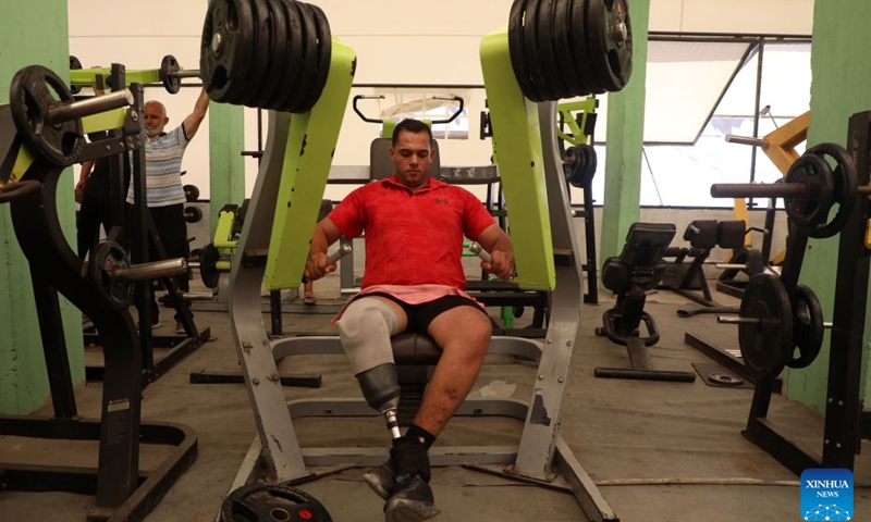 Palestinian bodybuilding coach Mahmoud Abu Madkour on a prosthetic leg exercises at the modest Al-Sakhra gym in al-Nuseirat refugee camp in the central Gaza Strip, on July 8, 2026. (Photo by Rizek Abdeljawad/Xinhua)

