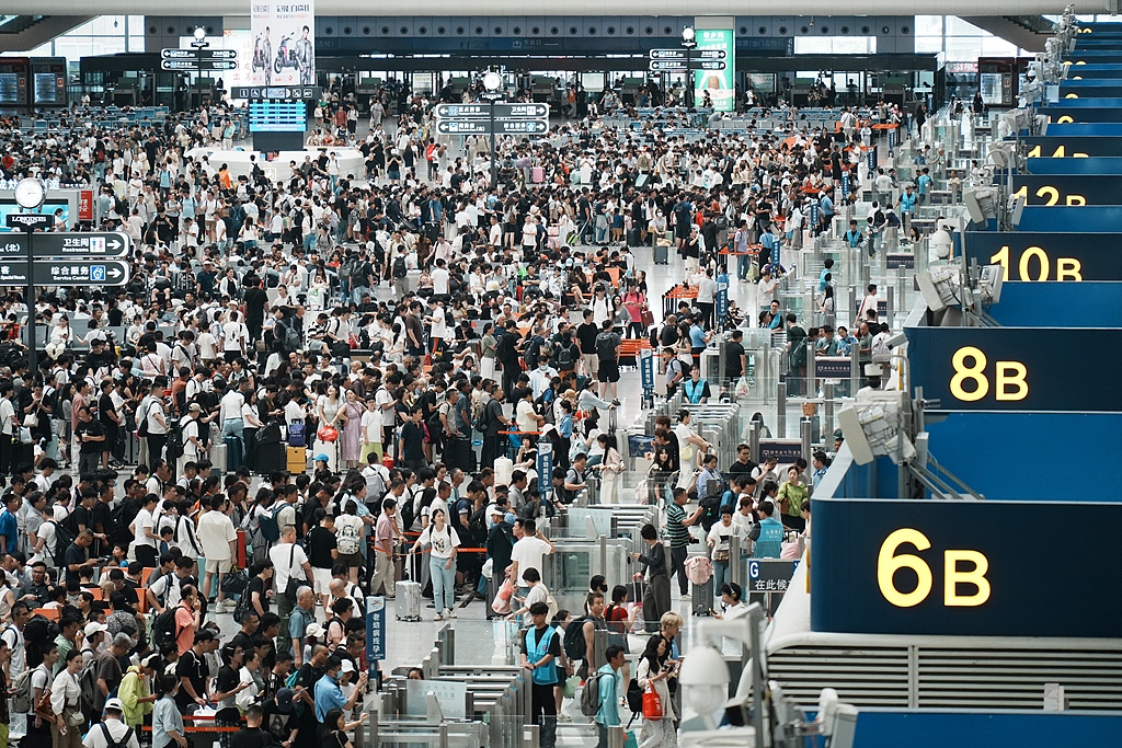 Crowds of passengers wait in the departure hall of Hangzhou East Railway Station in Hangzhou, East China's Zhejiang Province, on July 13, 2026, as Typhoon Bavi moves away. The station saw a peak in summer travel, driven by a combination of stranded passengers returning home and the seasonal surge in travel. China's national railway network is expected to handle 1.01 billion passenger trips during the 62-day summer travel rush.