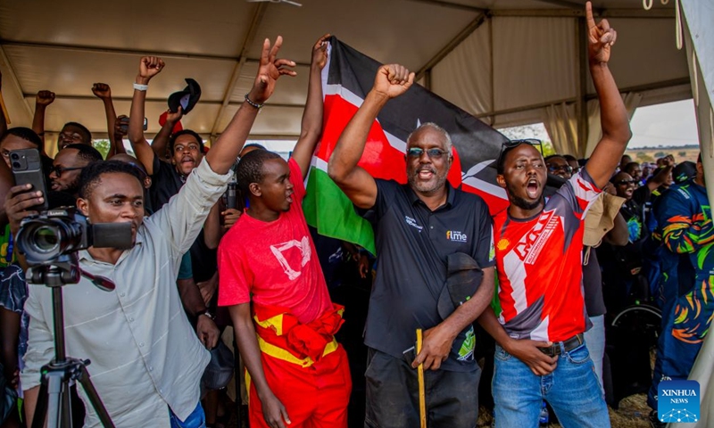Spectators and supporters from Kenya celebrate the awards won by Kenyan pilots during the Rwanda Mountain Gorilla Rally in Bugesera, Rwanda, July 12, 2026. The Rwanda Mountain Gorilla Rally is one of four official rounds of the 2026 FIA African Rally Championship. (Photo by Cyril Ndegeya/Xinhua)