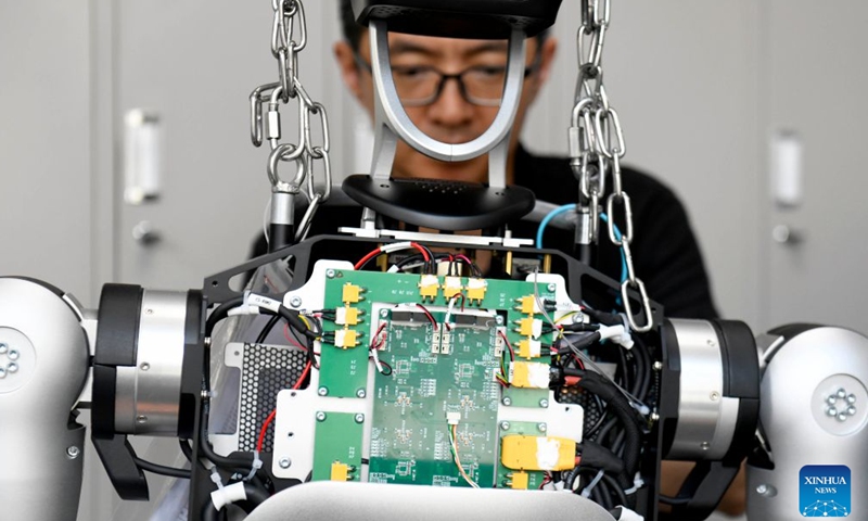 A staff member assembles a robot at Shandong Yobotics Intelligent Robot Co., Ltd. in Jinan High-tech Industrial Development Zone in Jinan, east China's Shandong Province, July 11, 2026.