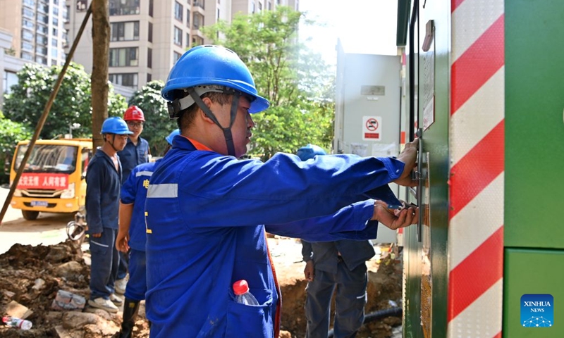 Staff members restore power supply at a community in Guigang City, south China's Guangxi Zhuang Autonomous Region, July 13, 2026. As Typhoon Maysak recedes, Guigang City has initiated efforts to pump out water, clear sludge, and restore power supply, striving to bring people's production and daily life back to normal. (Photo: Xinhua)