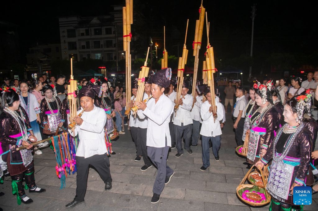 People of the Dong ethnic group perform Lusheng, a reed-pipe wind instrument, during a musical event in Congjiang County of southwest China's Guizhou Province, July 12, 2026. The event featuring performing arts of the Dong ethnic group and local specialty foods was held here on Sunday, attracting hundreds of tourists. (Photo: Xinhua)