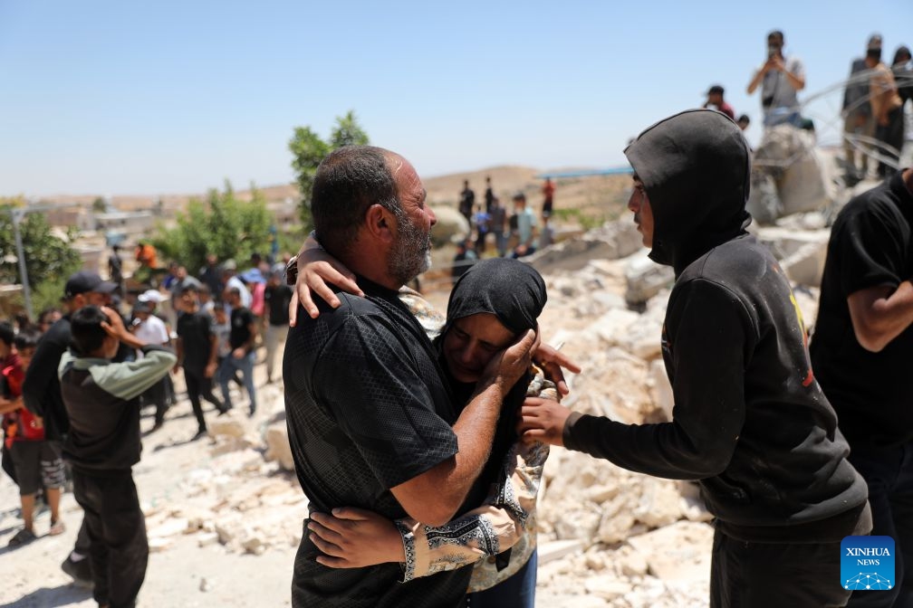 Palestinians grieve after Israeli excavators demolish a Palestinian house in the village of Deirat, east of Yatta, the West Bank, on July 14, 2026. (Photo: Xinhua)
