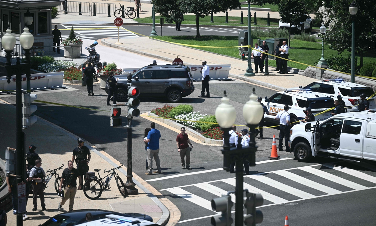 US Capitol Police officers and security personnel surround a vehicle that approached a security barricade near Constitution Avenue outside the US Capitol in Washington, DC, US, on July 13, 2026. Photo: VCG