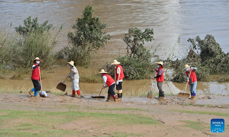 People clear mud after flooding at a park in Guigang, south China's Guangxi Zhuang Autonomous Region, July 13, 2026. (Photo: Xinhua)