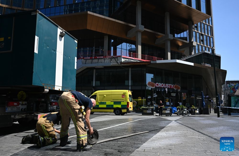 Firefighters work near the fire site of the Oxy building on De Brouckere Square, Brussels, Belgium, July 14, 2026. Multiple people have died on Tuesday in a fire at the well-known Oxy building on De Brouckere Square, in the center of Brussels. According to local media, 6 people are still missing. The fire brigade has deployed en masse for a major search and rescue operation. (Photo: Xinhua)