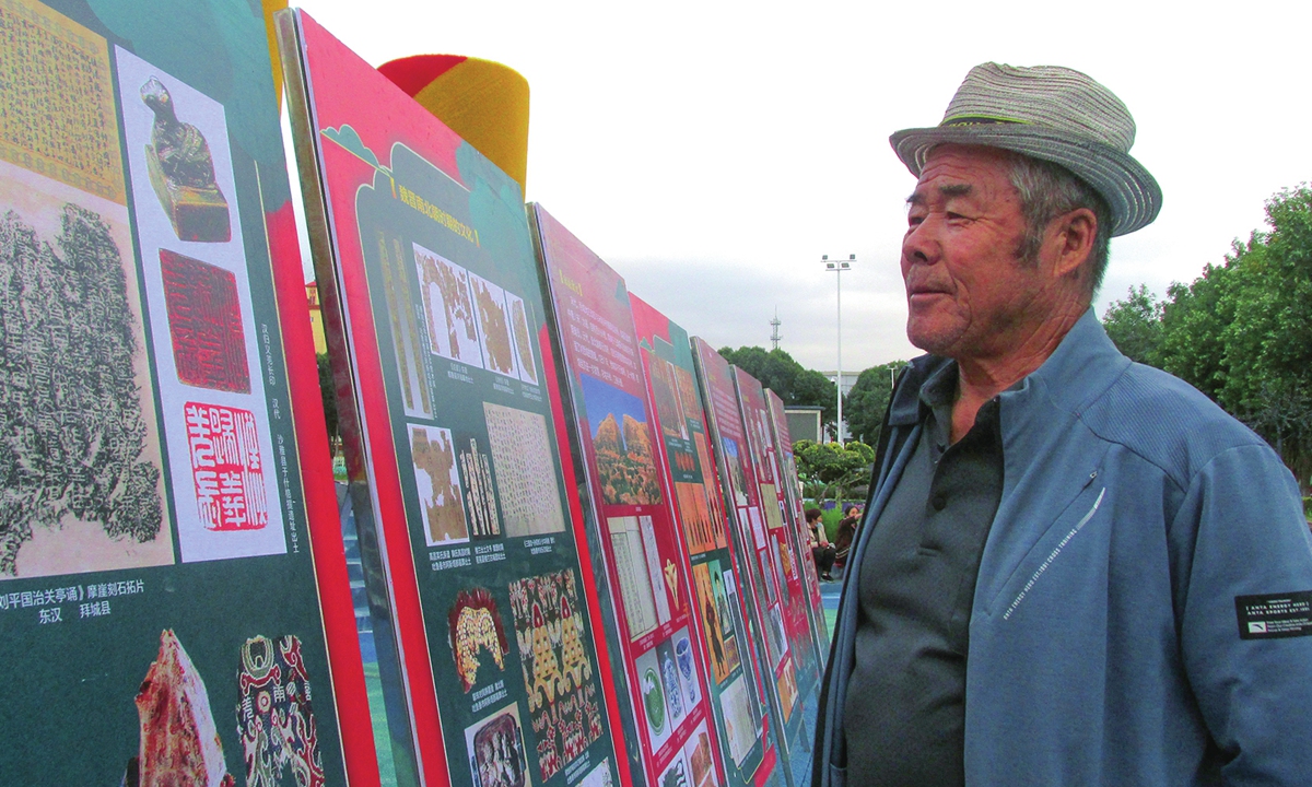 A resident of Xinjiang's Tacheng prefecture views exhibits brought by the region's 