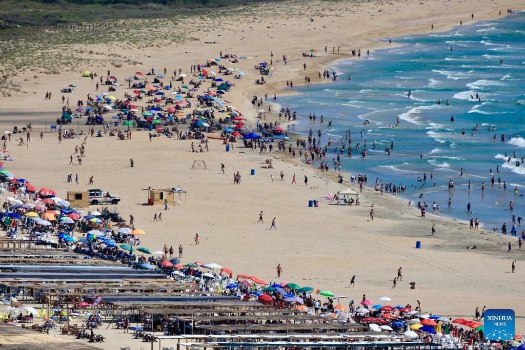 People enjoy themselves on a beach in Tyre, Lebanon, July 12, 2026. (Photo: Xinhua)