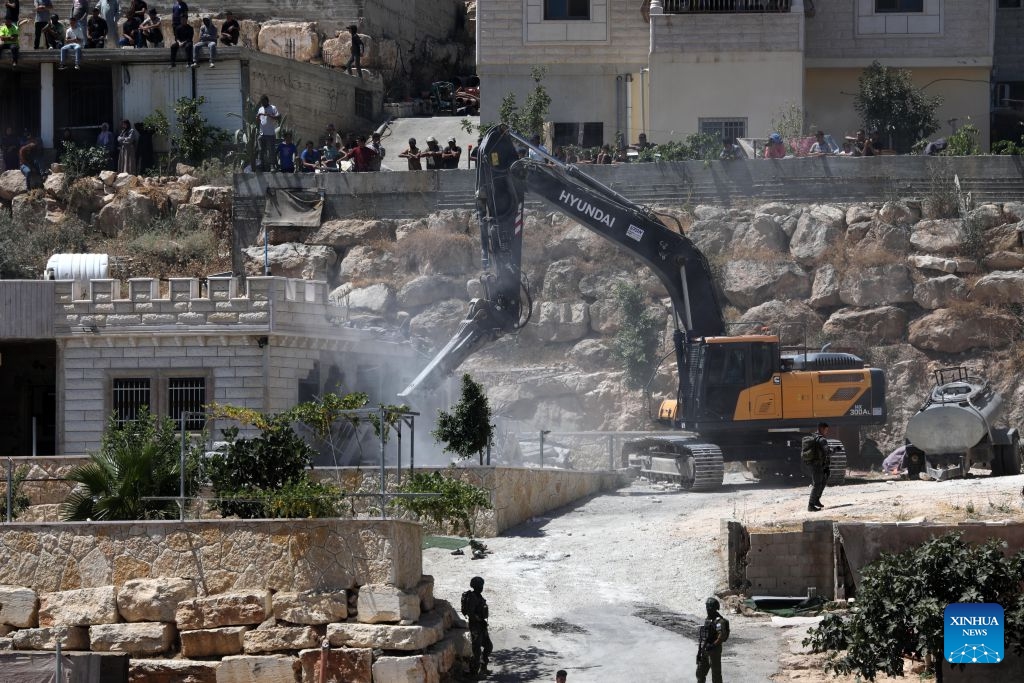 An Israeli excavator demolishes a Palestinian house in the village of Deirat, east of Yatta, the West Bank, on July 14, 2026. (Photo: Xinhua)