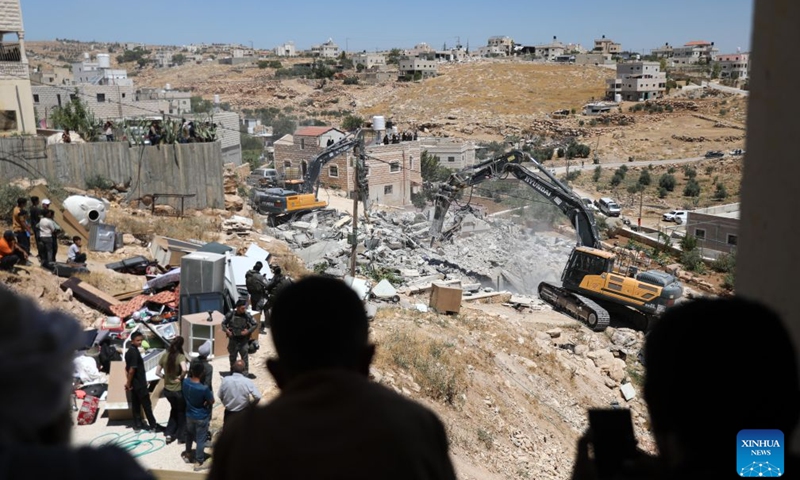 Israeli excavators demolish a Palestinian house in the village of Deirat, east of Yatta, the West Bank, on July 14, 2026. (Photo: Xinhua)