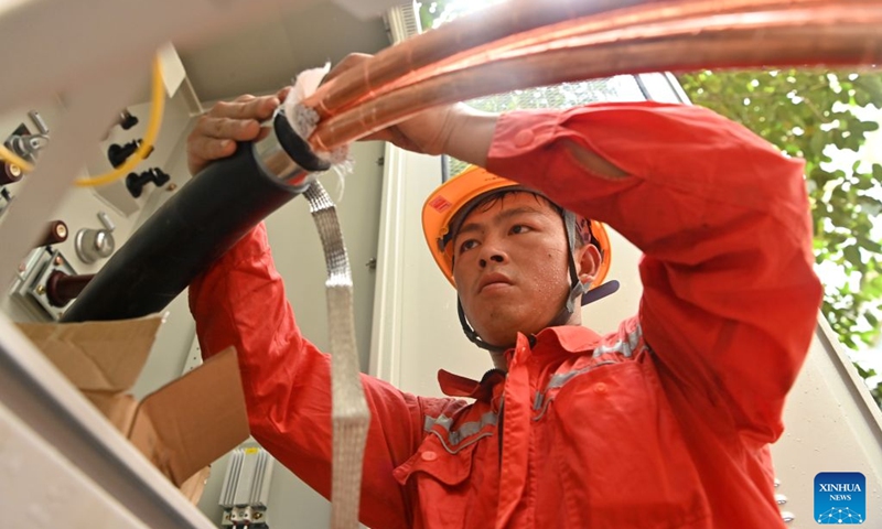 A staff member performs emergency repairing at a residential compound in Guigang City, south China's Guangxi Zhuang Autonomous Region, July 14, 2026. The power supplier in Guigang has mobilized all hands available to restore power supply as flooding inflicted by typhoon Maysak subsides in the city. (Photo: Xinhua)