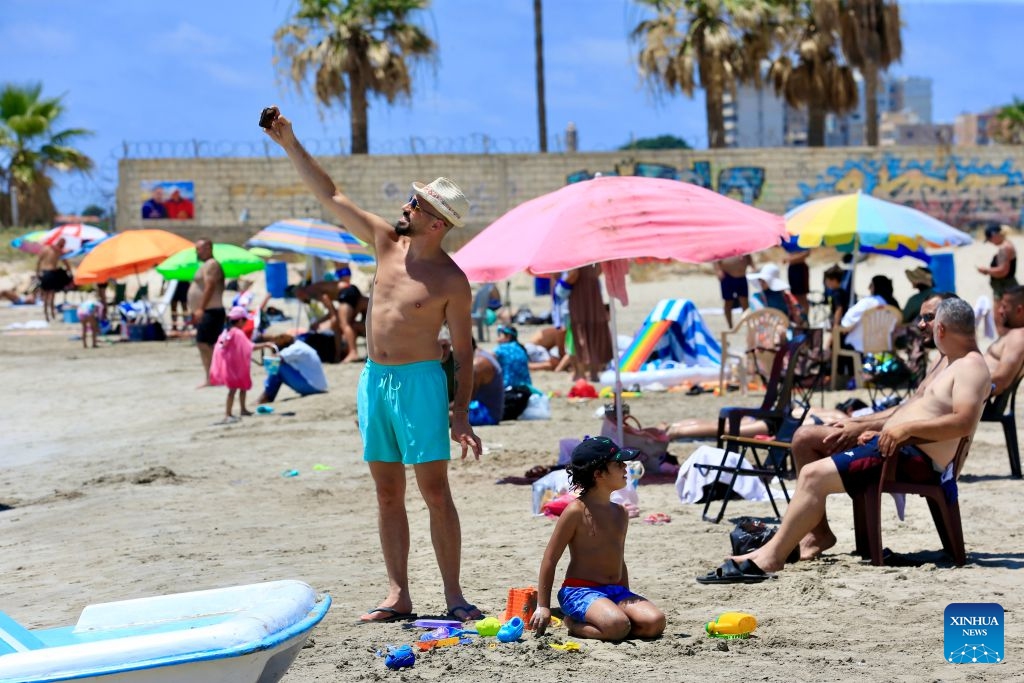 People enjoy themselves on a beach in Tyre, Lebanon, July 12, 2026. (Photo: Xinhua)
