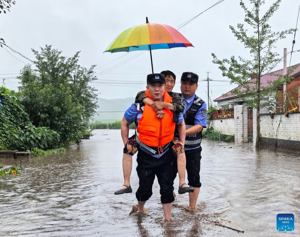 Police officers evacuate a villager at Jinlong Village of Kaiyuan City, northeast China's Liaoning Province, July 14, 2026. Recently, heavy rainfall has caused flooding in parts of Liaoning Province. Local officials have worked on the front line to evacuate residents and provide them with temporary relocation. (Photo: Xinhua)