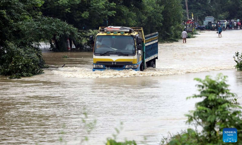 A truck drives in floodwater in Cox's Bazar district, Bangladesh, July 12, 2026. Floods that have swept parts of Bangladesh for about a week have killed 51 people, said a senior official on Sunday. According to the latest daily disaster situation report released by the country's Ministry of Disaster Management and Relief, more than 1.02 million people were marooned by floods in seven out of the country's total 64 districts. (Photo: Xinhua)