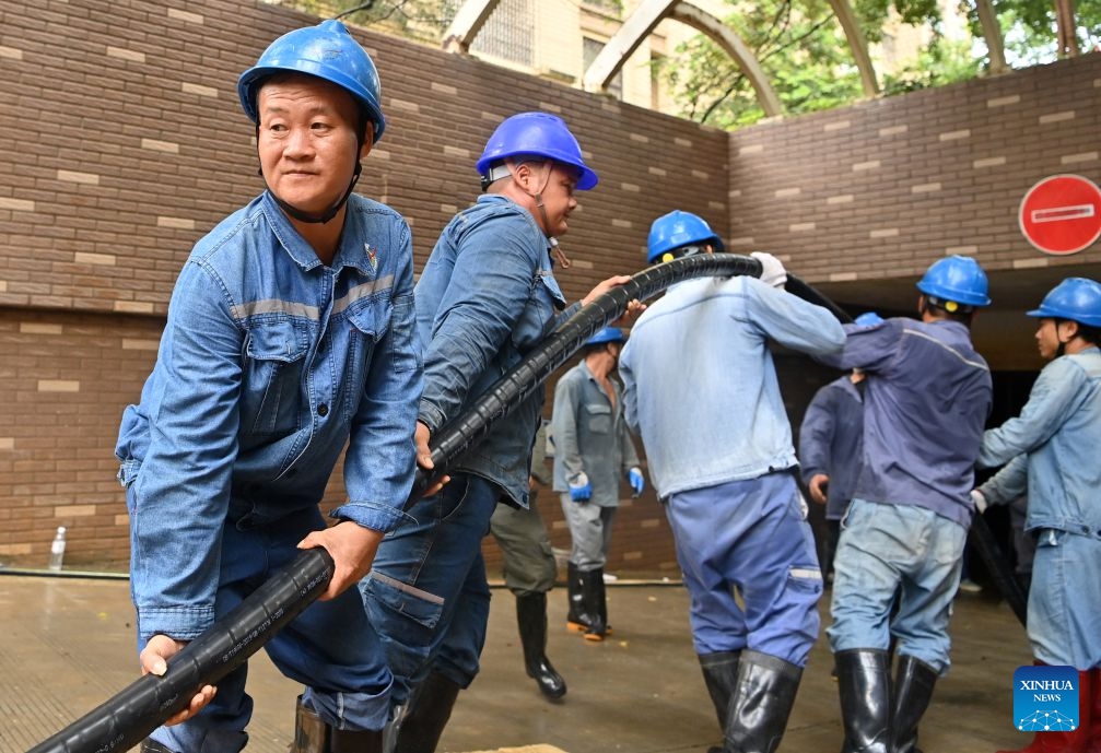 Staff members perform emergency repairing at a residential compound in Guigang City, south China's Guangxi Zhuang Autonomous Region, July 14, 2026. The power supplier in Guigang has mobilized all hands available to restore power supply as flooding inflicted by typhoon Maysak subsides in the city. (Photo: Xinhua)
