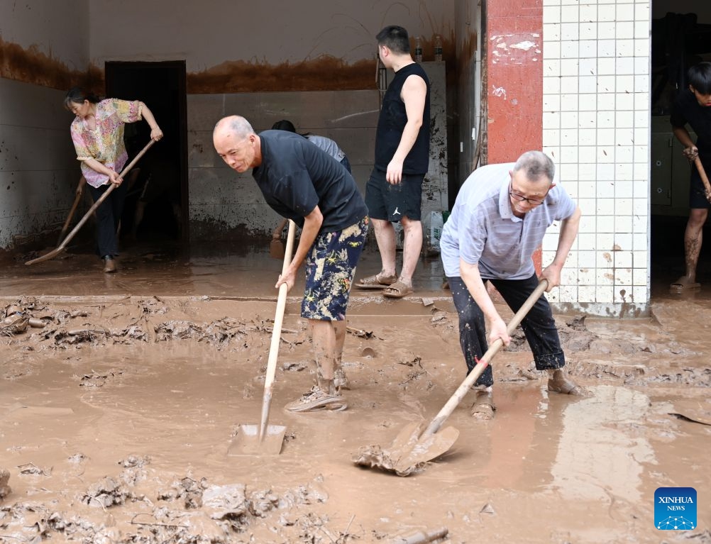 Staff members clear sludge in Mabian Yi Autonomous County of Leshan City, southwest China's Sichuan Province, July 11, 2026. Torrential rain has caused flooding in multiple places in China recently. In rescue across the country, rescuers have risen to the occasion to protect the people. (Photo: Xinhua)