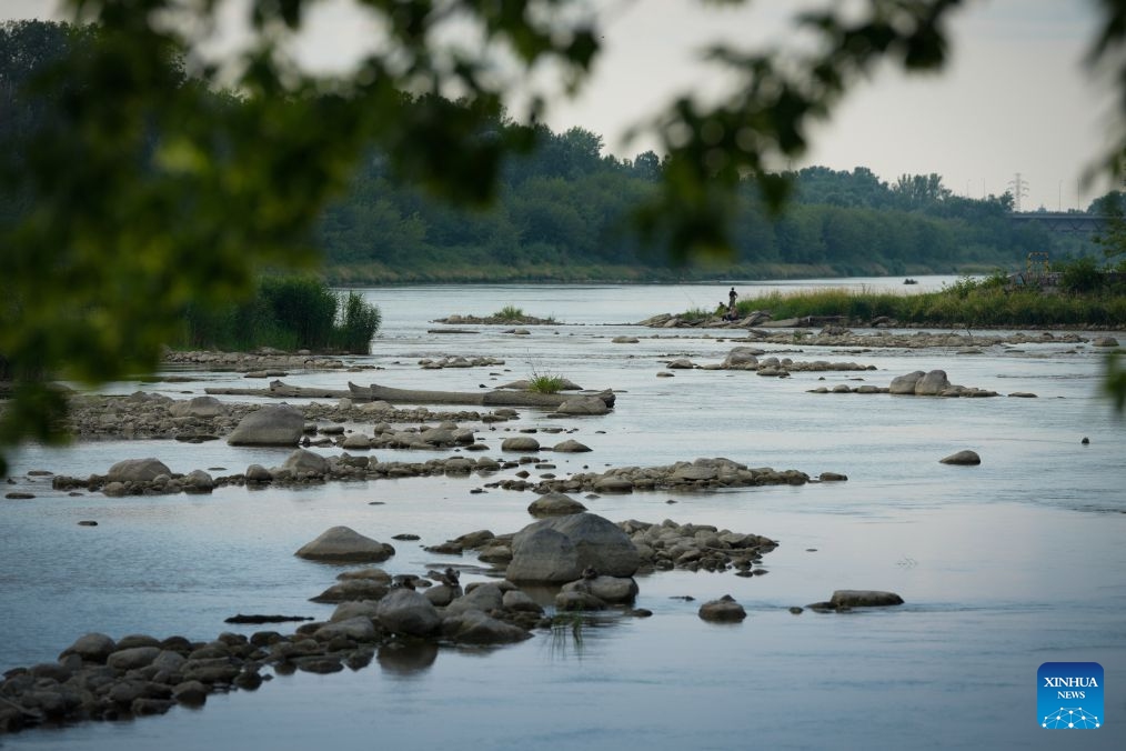 Low water levels expose shallow areas of the Vistula River in Warsaw, Poland, July 13, 2026. Poland's longest river, the Vistula, has fallen to historically low water levels amid drought. Recent data from the Institute of Meteorology and Water Management showed that the river level at the Warsaw-Bulwary monitoring station had dropped to 19 centimeters, far below the normal level of around 230 centimeters. (Photo: Xinhua)