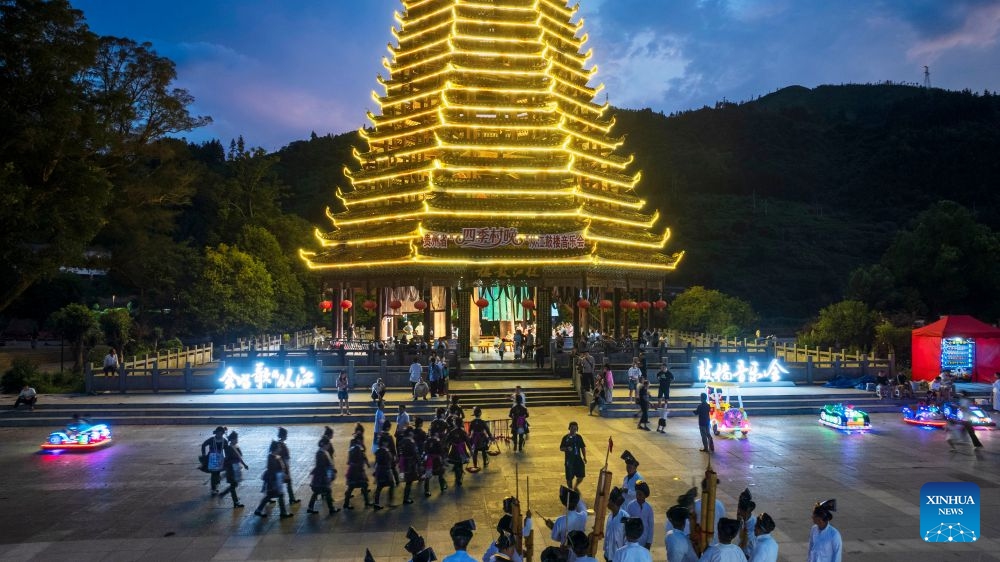A drone photo taken on July 12, 2026 shows people attending a musical event in Congjiang County of southwest China's Guizhou Province. The event featuring performing arts of the Dong ethnic group and local specialty foods was held here on Sunday, attracting hundreds of tourists. (Photo: Xinhua)