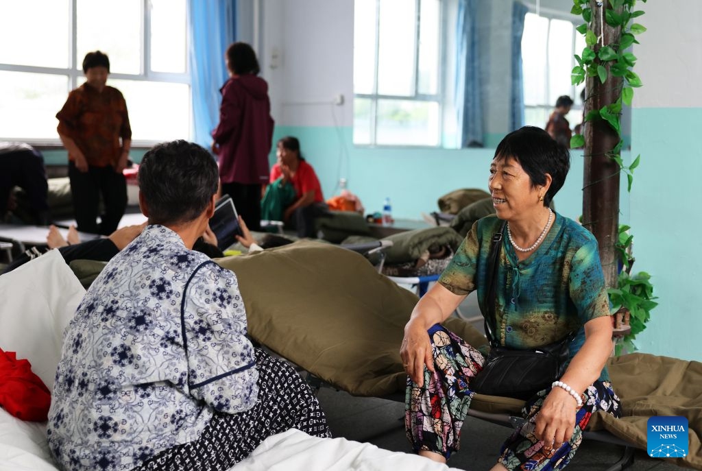 Villagers chat at a temporary relocation in Kaoshan Town of Kaiyuan City, northeast China's Liaoning Province, July 14, 2026. Recently, heavy rainfall has caused flooding in parts of Liaoning Province. Local officials have worked on the front line to evacuate residents and provide them with temporary relocation. (Photo: Xinhua)