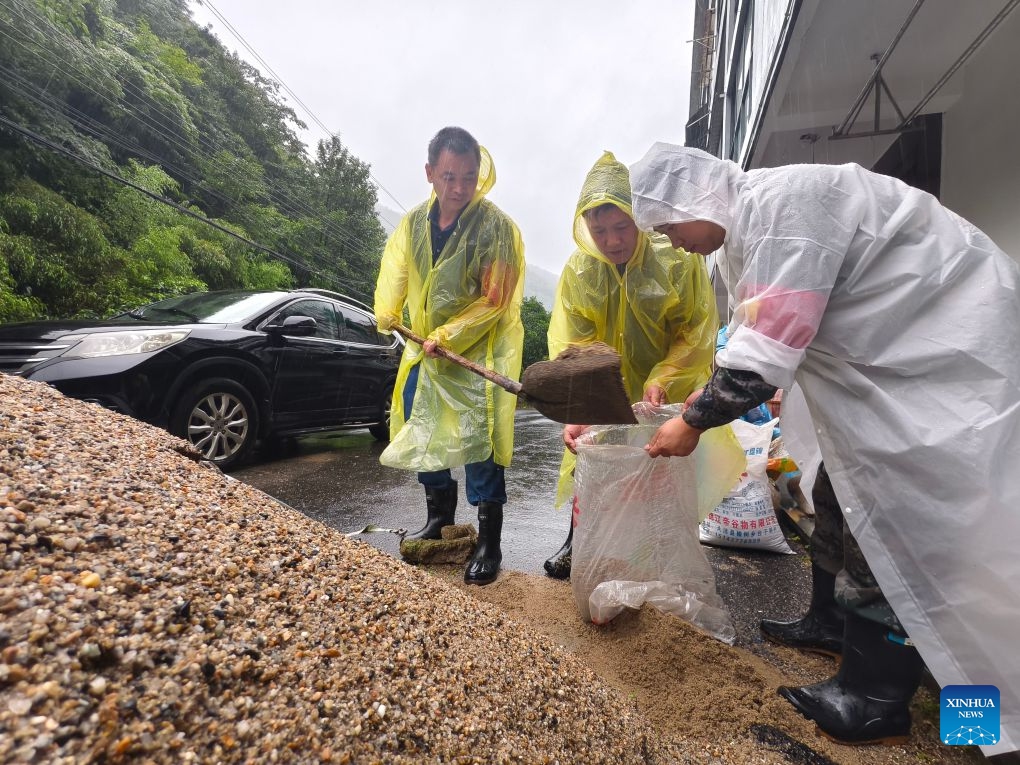 This photo taken with a mobile phone shows staff members preparing sandbags in Tianmushan Town, Lin'an District of Hangzhou City, east China's Zhejiang Province, July 12, 2026. Torrential rain has caused flooding in multiple places in China recently. In rescue across the country, rescuers have risen to the occasion to protect the people. (Photo: Xinhua)