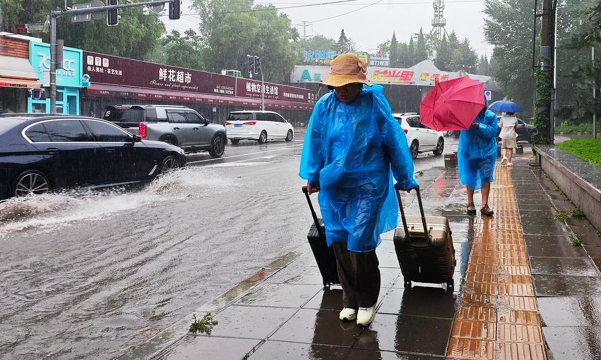 Citizens walk amid rain in Shenyang, northeast China's Liaoning Province, on July 13, 2026. Photo: Xinhua