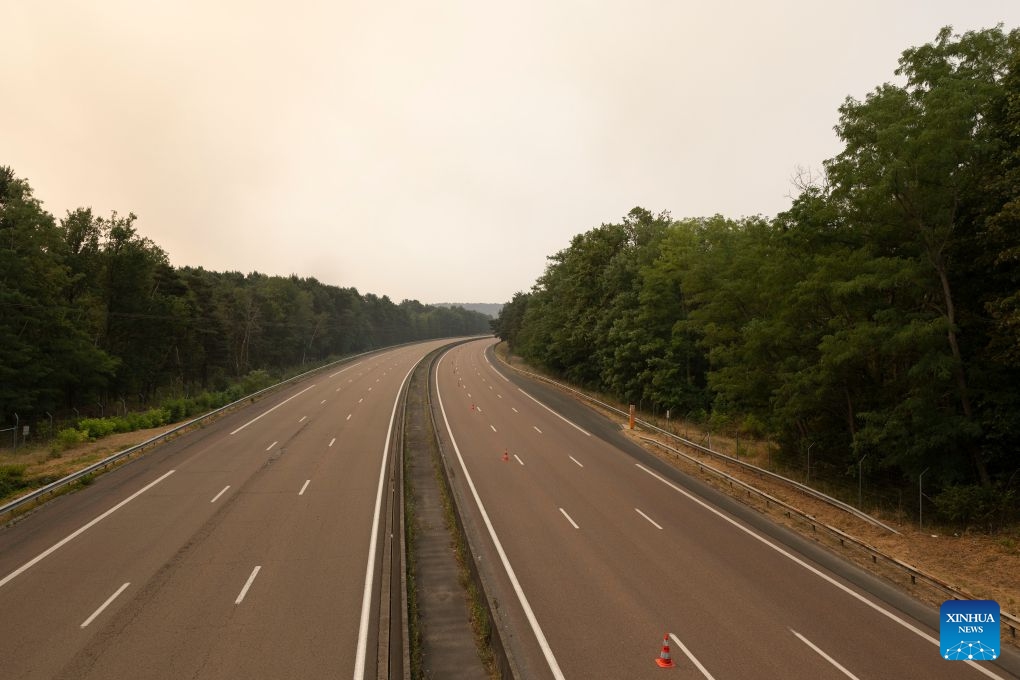 This photo taken on July 14, 2026 shows a closed road due to a wildfire in Seine-et-Marne, France. French police have detained 59 people across the country in connection with wildfires, including two suspects linked to the blaze in the Fontainebleau forest in Seine-et-Marne department, southeast of Paris, French Interior Minister Laurent Nunez said on Monday. The wildfire in the Fontainebleau forest broke out on Sunday evening and continued to spread on Monday. (Photo: Xinhua)