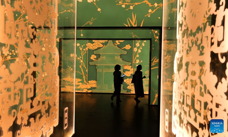 People visit A Garden Within: An Immersive Light and Shadow Exhibition of the Qianlong Garden at National Museum of Classic Books in Beijing, capital of China, July 14, 2026. The exhibition, which features multiple immersive scenarios and interactive installations, is held here from July 9 to Dec. 6. The Qianlong Garden, also known as the Garden of the Palace of Tranquil Longevity, was built by Emperor Qianlong (1711-1799) of Qing Dynasty (1644-1911) as a private retreat for his later years in the Forbidden City, or today's Palace Museum. (Photo: Xinhua)