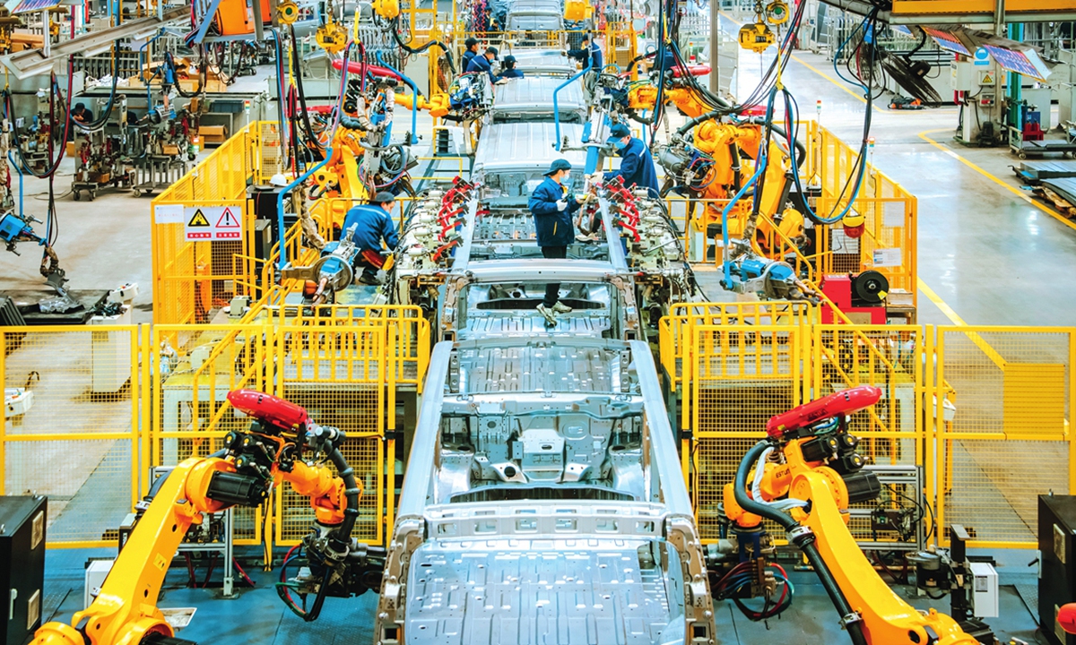 Staff members from a local NEV enterprise catch up on orders on the production line in Ganzhou, East China's Jiangxi Province on December 26, 2023.Photo: VCG