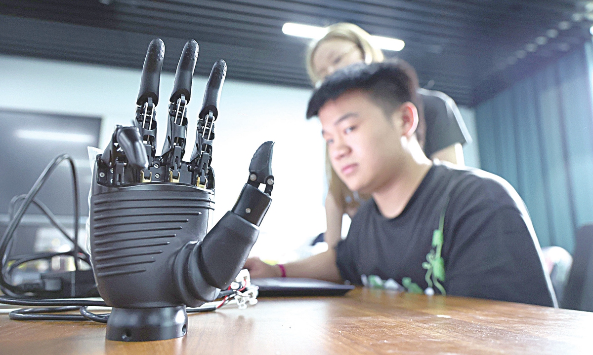 A university's faculty and a student jointly develop a motion-sensing bionic hand in the Shapingba district of Southwest China's Chongqing Municipality on June 24, 2026. 