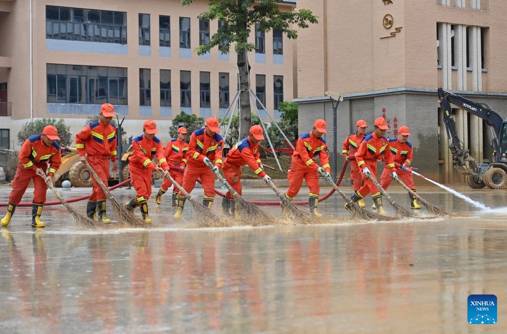 People remove sludge at a middle school in Guigang City, south China's Guangxi Zhuang Autonomous Region, July 15, 2026. Efforts are underway to facilitate flood relief and recovery in Guangxi, which has been hit by severe rainstorms and flooding caused by Typhoon Maysak. (Photo: Xinhua)
