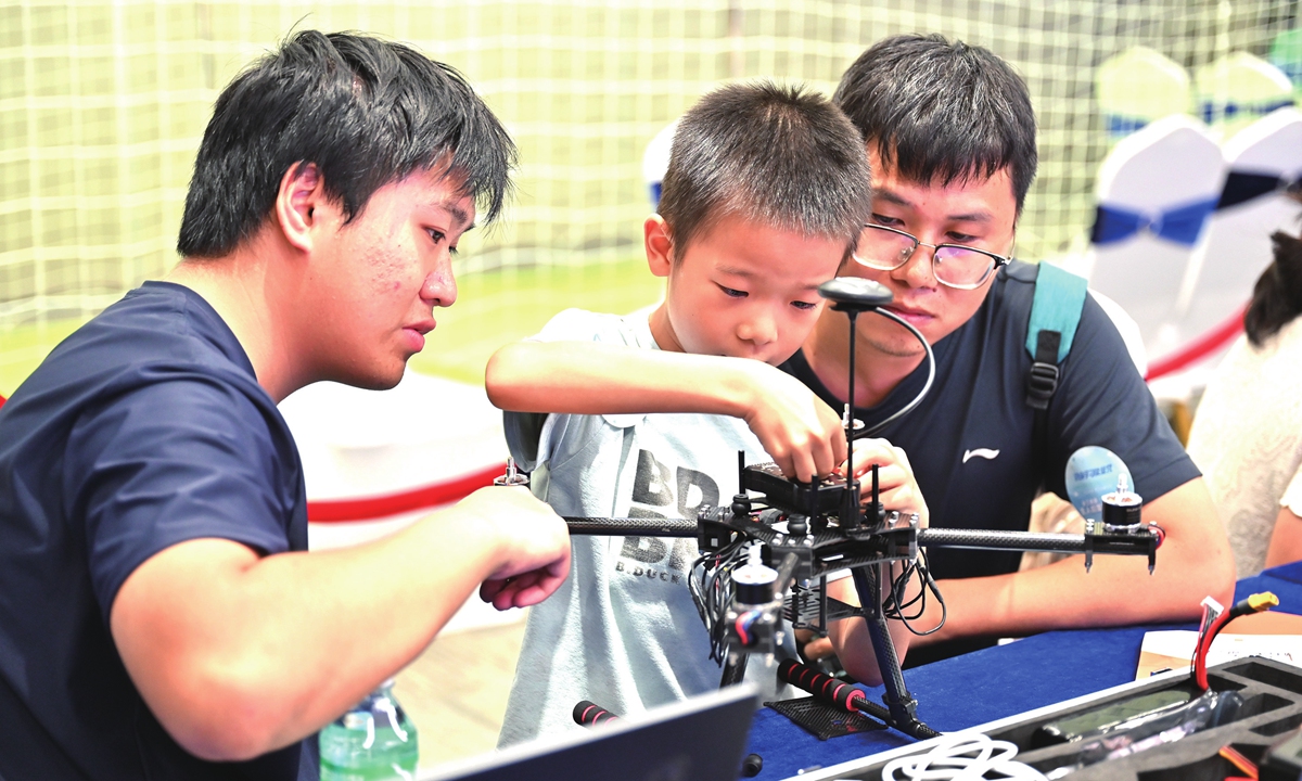 A boy assembles a drone in Guangzhou, South China's Guangdong Province, on July 11, 2026. Photos on this page: VCG
