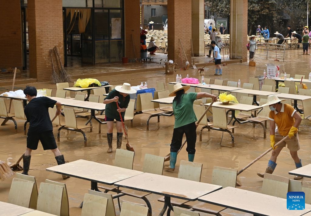 People clear mud after flooding at a high school in Guigang, south China's Guangxi Zhuang Autonomous Region, July 15, 2026. Flood relief and recovery efforts were underway after the city was hit by severe rainstorms and flooding caused by Typhoon Maysak. (Photo: Xinhua)