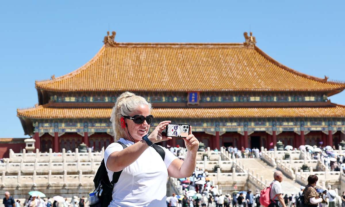 A foreign visitor takes a picture at the Palace Museum in Beijing on June 21, 2026. Photo: VCG