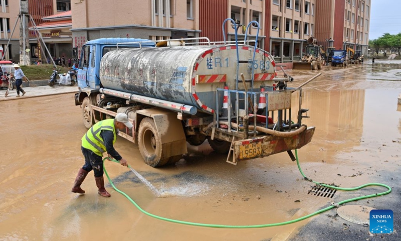 People clear mud after flooding at a high school in Guigang, south China's Guangxi Zhuang Autonomous Region, July 15, 2026. Flood relief and recovery efforts were underway after the city was hit by severe rainstorms and flooding caused by Typhoon Maysak. (Photo: Xinhua)