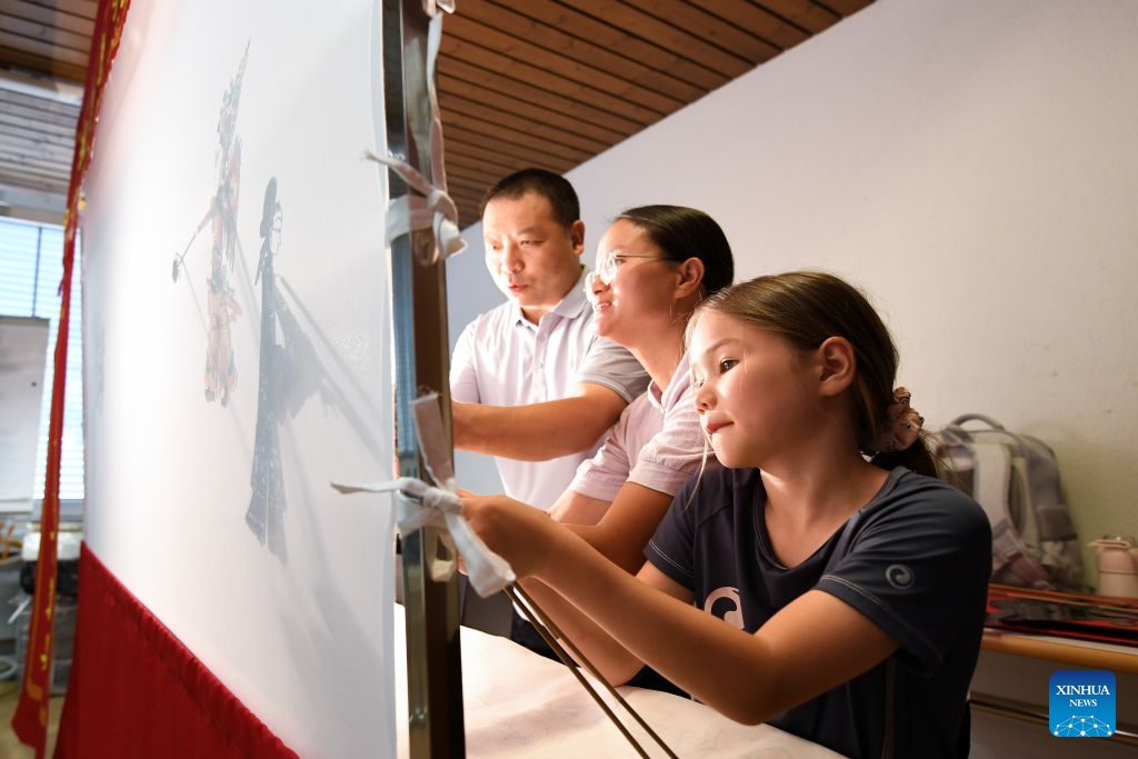 Members of a Chinese culture summer camp try Chinese shadow puppetry in Bern, Switzerland, July 14, 2026. A summer camp featuring traditional Chinese culture opened here on Tuesday. (Photo: Xinhua)