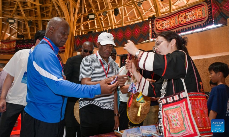 Diplomatic envoys learn about local culture in Maona Village of Shuiman Township, Wuzhishan City, south China's Hainan Province, July 23, 2026. At the invitation of the Chinese Ministry of Foreign Affairs, more than 30 ambassadors and senior diplomats visited Sanya, Wuzhishan, Qionghai, Wenchang and Haikou in south China's Hainan Province from Wednesday to Saturday. During the visit, they explored Hainan's scientific and technological innovation, and the development of the Hainan Free Trade Port. (Xinhua/Yang Guanyu)