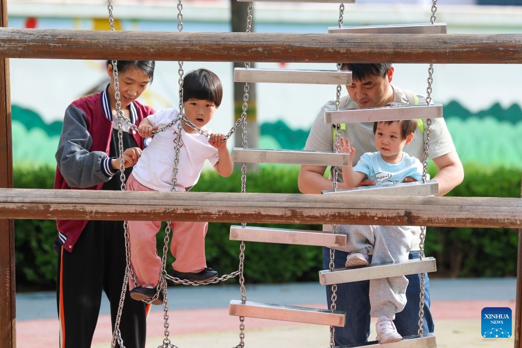 Children have fun at a central park in Shijiazhuang, north China's Hebei Province, May 18, 2026. During China's 14th Five-Year Plan period (2021-2025), over 240,000 old urban residential compounds were renovated across the country, benefiting more than 40 million households and 110 million residents. (Photo: Xinhua)