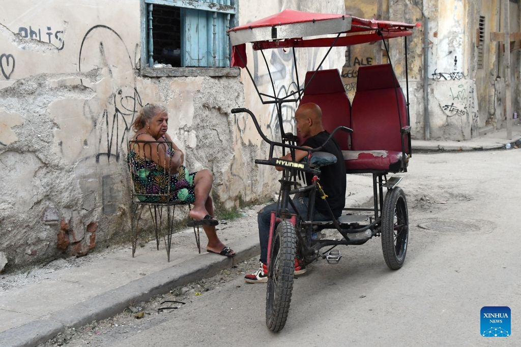 People chat on the street during a nationwide blackout in Havana, capital of Cuba, July 14, 2026. Cuba was hit by a third nationwide blackout in a little over a week on Tuesday, the National Electric Union said. (Photo: Xinhua)