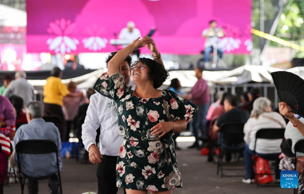 People dance at the San Angel Flower Fair in Mexico City, Mexico, July 14, 2026. The annual event features flower markets, handicraft displays and cultural performances, highlighting local horticulture traditions, folk art and the historic charm of the district. (Photo: Xinhua)
