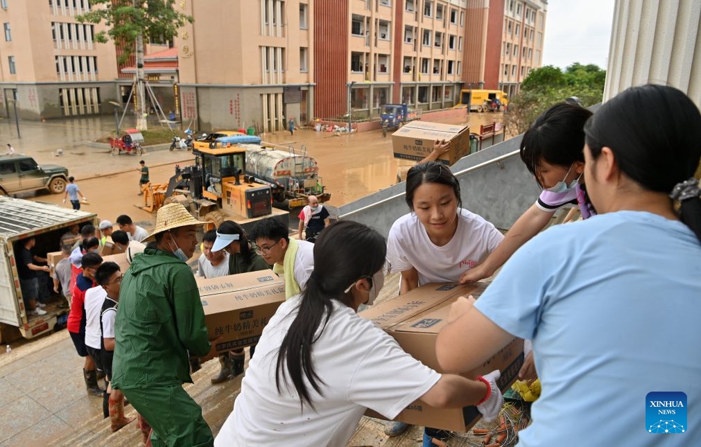 People transfer disaster relief supplies at a middle school in Guigang City, south China's Guangxi Zhuang Autonomous Region, July 15, 2026. Efforts are underway to facilitate flood relief and recovery in Guangxi, which has been hit by severe rainstorms and flooding caused by Typhoon Maysak. (Photo: Xinhua)