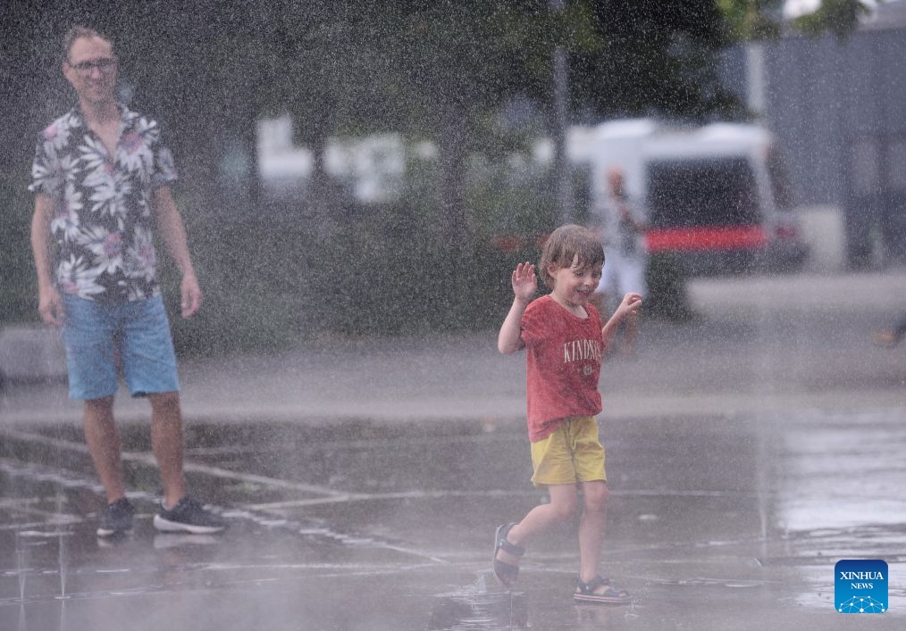 A boy cools off at a splash pad during a heatwave in Vienna, Austria, July 15, 2026. (Photo: Xinhua)
