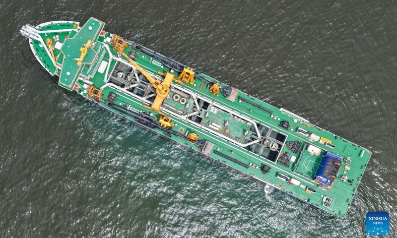 An aerial drone photo taken on July 14, 2026 shows the Junguang dredger at the Beibu Gulf in south China's Guangxi Zhuang Autonomous Region. The Junguang, a mega dredger with a 35,000 cubic meter capacity, was recently put into operation. Measuring 198 meters in length, with a maximum dredging depth of 120 meters and a deadweight of 60,483 tonnes, the vessel is the largest of its kind in Asia. (Photo: Xinhua)