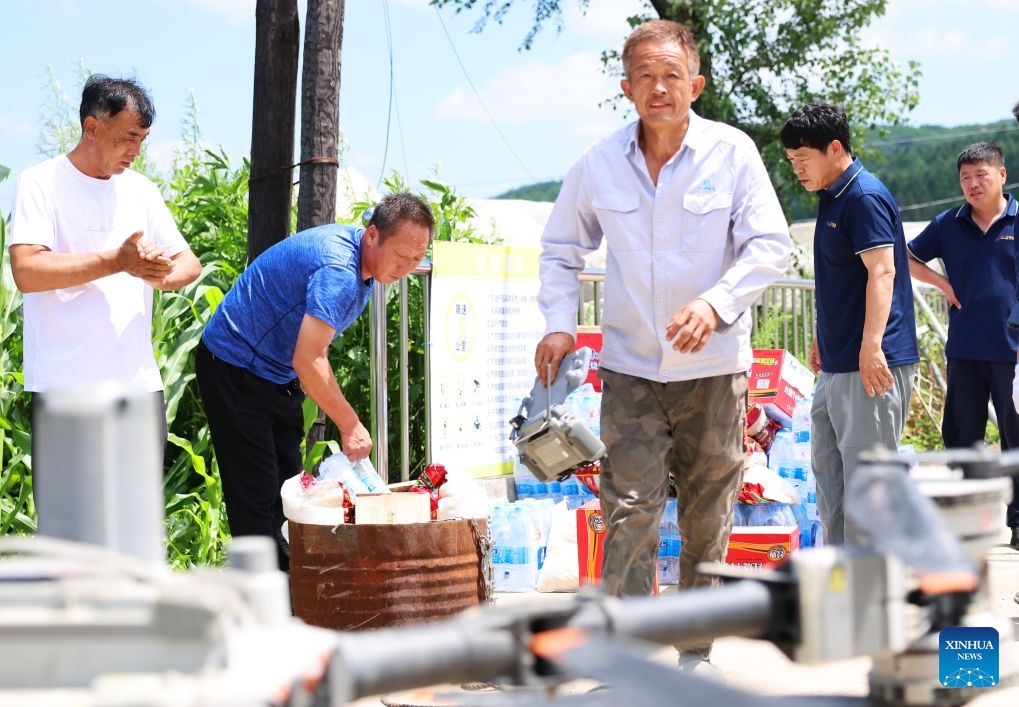 Staff members prepare relief supplies to be delivered by drones in Huangqizhai Village of Kaiyuan City, northeast China's Liaoning Province, July 15, 2026. On Tuesday, China's national commission for disaster prevention, reduction and relief activated a Level-IV national disaster relief emergency response for Liaoning Province, which was hit by rainstorms and flooding. China has a four-tier emergency response system, with Level I being the most severe. (Photo: Xinhua)