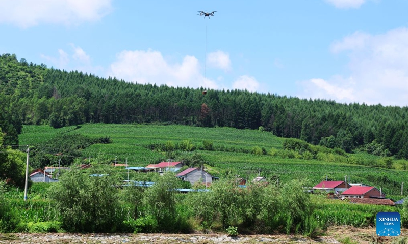A drone is seen delivering relief supplies in Huangqizhai Village of Kaiyuan City, northeast China's Liaoning Province, July 15, 2026. On Tuesday, China's national commission for disaster prevention, reduction and relief activated a Level-IV national disaster relief emergency response for Liaoning Province, which was hit by rainstorms and flooding. China has a four-tier emergency response system, with Level I being the most severe. (Photo: Xinhua)