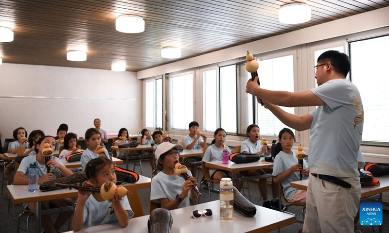 Members of a Chinese culture summer camp learn about Hulusi, a traditional Chinese wind instrument, in Bern, Switzerland, July 14, 2026. A summer camp featuring traditional Chinese culture opened here on Tuesday. (Photo: Xinhua)