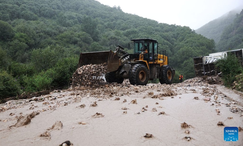 A machinery cleans up silt at the flood-hit area in Weiyuan County, northwest China's Gansu Province, July 27, 2026. The flash flood, triggered by sudden heavy rainfall, hit a scenic area in Weiyuan County, Dingxi City, on Sunday afternoon, leaving 10 people dead and 23 injured as of 6 p.m.

