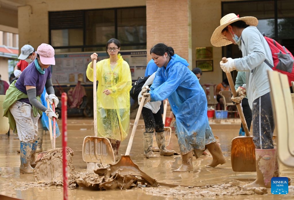 People clear mud after flooding at a high school in Guigang, south China's Guangxi Zhuang Autonomous Region, July 15, 2026. Flood relief and recovery efforts were underway after the city was hit by severe rainstorms and flooding caused by Typhoon Maysak. (Photo: Xinhua)