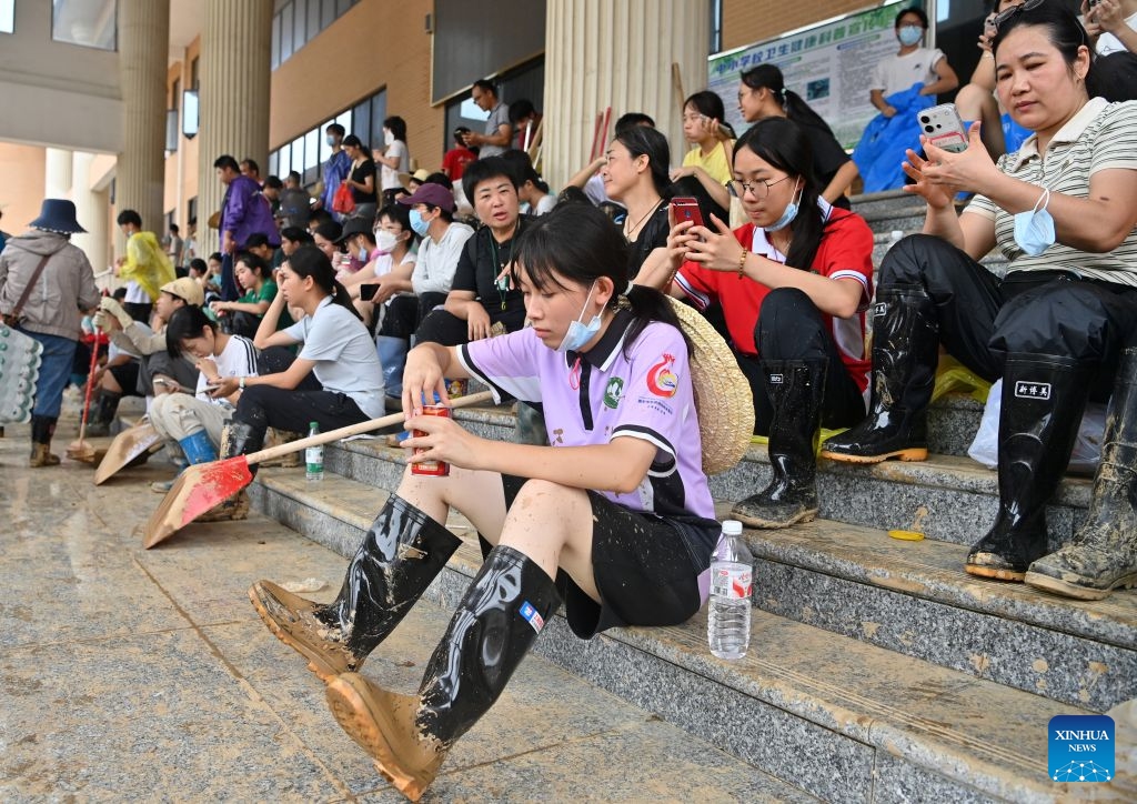 People take a break during the clearing work at a middle school in Guigang City, south China's Guangxi Zhuang Autonomous Region, July 15, 2026. Efforts are underway to facilitate flood relief and recovery in Guangxi, which has been hit by severe rainstorms and flooding caused by Typhoon Maysak. (Photo: Xinhua)